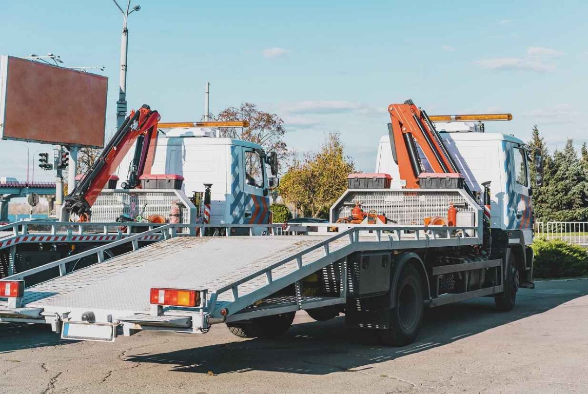 Modern flatbed towing trucks ready for safe vehicle transport in Des Moines, WA