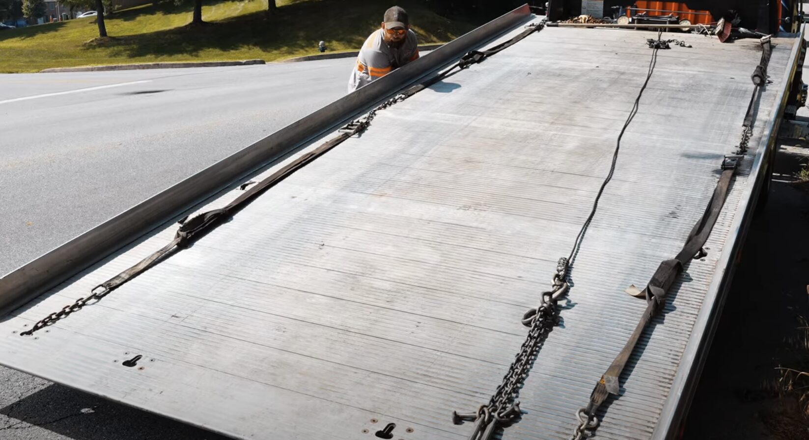 Professional towing equipment - Safe vehicle transport preparation Tow truck flatbed ready for vehicle loading with proper safety equipment